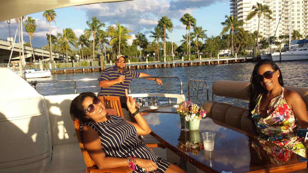 Three beautiful people enjoying their day on a yacht