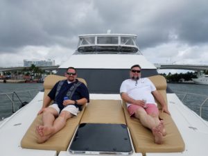 Two men relaxing on the yacht with beverage