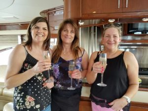 Three women wearing black tops on the yacht