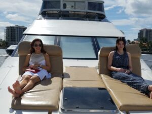 Two beautiful women enjoying their day in the yacht