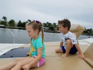 Two toddlers playing around the yacht