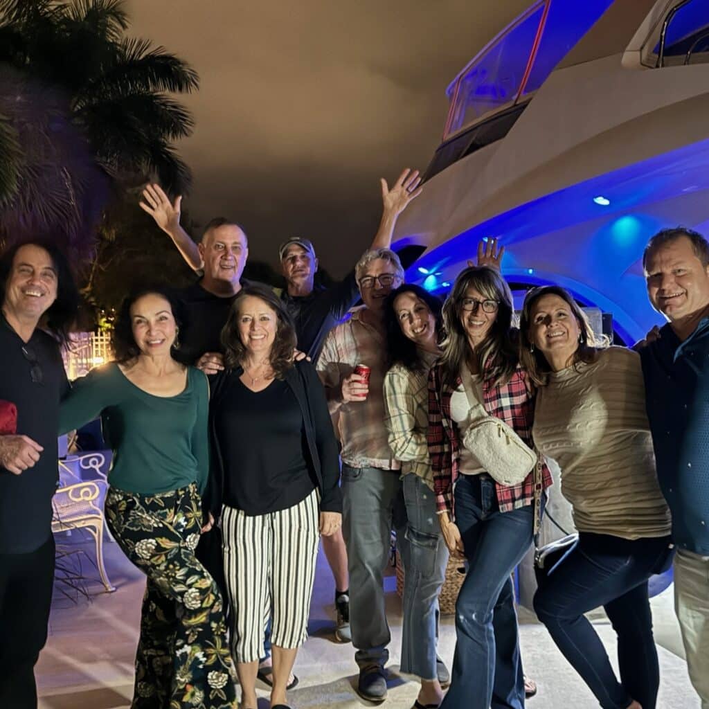 Private event on a yacht charter. A group of friends enjoy the launch from the dock with a group hug.