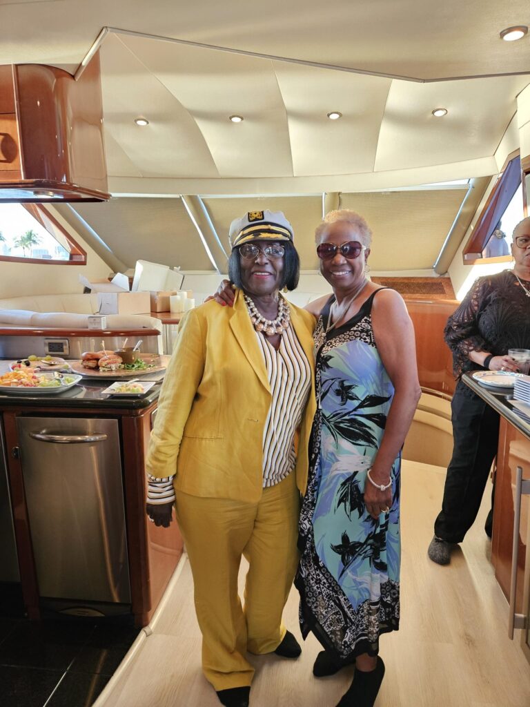 Special event birthday yacht cruise enjoyed by to older women dressed for fun.